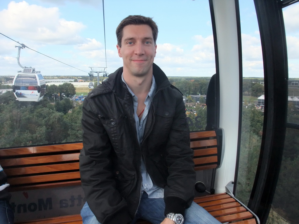 Tim in the Floriadebaan funicular, with a view on the Floriade park