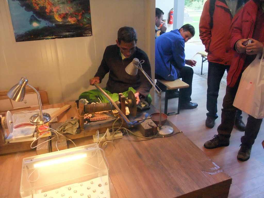 Man making clothes in the pavilion of Sri Lanka at the World Show Stage section