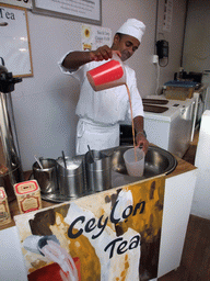 Man making Ceylon Tea in the pavilion of Sri Lanka at the World Show Stage section