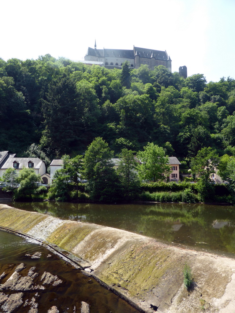 The Vianden Castle, a small dam in the Our river and the Rue du Vieux Marche street, viewed from the Rue Victor Hugo street