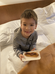 Max with a chocolate bread in our room at the fourth floor of the Benediktushaus im Schottenstift hotel