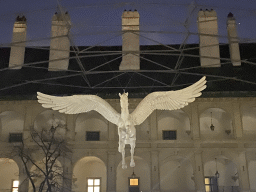 Horse statue hanging at the Stallburg building at the Reitschulgasse street, by night