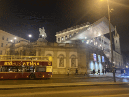 Bus in front of the Albertina museum with the Archduke Albrecht Monument, viewed from the Albertinaplatz square, by night