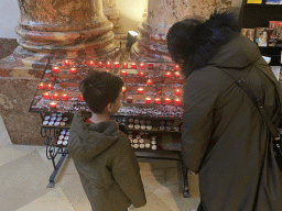 Miaomiao and Max lighting a candle at the nave of the Karlskirche church