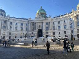 Front of the Hofburg palace and christmas stalls at the Michaelerplatz square