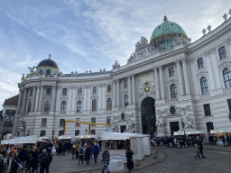 Front of the Hofburg palace and christmas stalls at the Michaelerplatz square