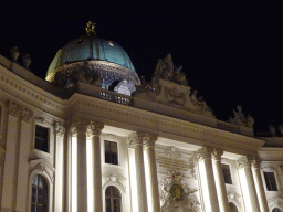 Facade and dome of the Hofburg palace, viewed from the Michaelerplatz square, by night