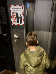 Max in front of the elevator to the viewing platform at the North Tower of St. Stephen`s Cathedral