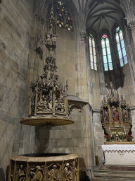 Baptismal font and altar at St. Katherine`s Chapel at St. Stephen`s Cathedral