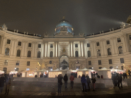 Front of the Hofburg palace and christmas stalls at the Michaelerplatz square, by night