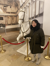 Miaomiao with a horse statue at the lobby of the Spanish Riding School