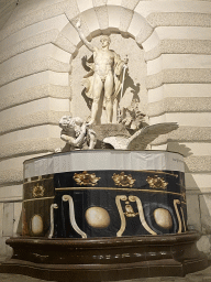 Fountain in front of the Hofburg palace at the Michaelerplatz square, under renovation, by night