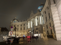 Front of the Hofburg palace and christmas stalls at the Michaelerplatz square, by night