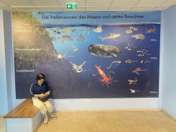 Miaomiao in front of information on sea animals at the `The Sea and Us` exhibition at the sixth floor of the Haus des Meeres aquarium