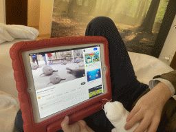 Max watching YouTube on the iPad at our room at the fourth floor of the Benediktushaus im Schottenstift hotel