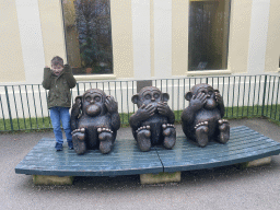 Max with statues of the Three Wise Monkeys at the Schönbrunn Zoo