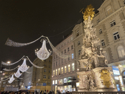 Decorative lights and the Pestsäule column at the Graben square, by night