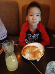 Max eating a croissant at the Stadtcafé restaurant