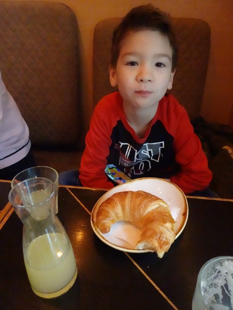 Max eating a croissant at the Stadtcafé restaurant