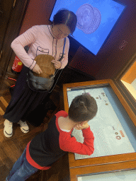 Miaomiao and Max with information on Chinese coins at Gallery III of the exhibition `Around the World in 80 Coins` at the second floor of the Kunsthistorisches Museum Wien