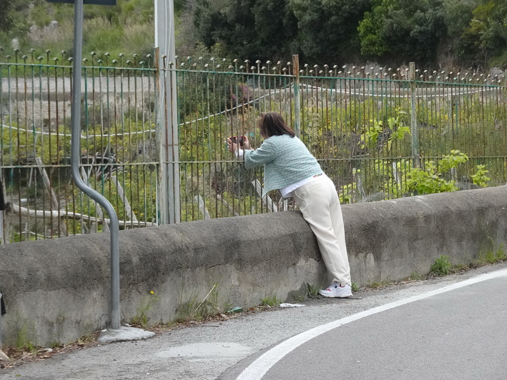 Miaomiao making photos at a building at the Capo d`Orso cliff along the Amalfi Drive