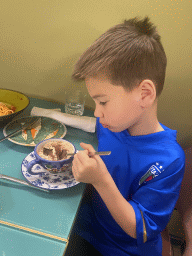 Max eating tiramisu at the Ristorante Evu` restaurant