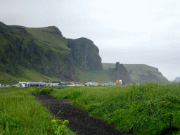 Buildings at the west side of town and mountains, viewed from the parking lot of the Black Sand Beach