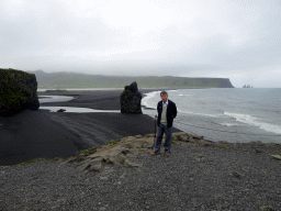 Miaomiao`s father at the lower viewpoint of the Dyrhólaey peninsula, with a view on Kirkjufjara beach and Reynisfjara Beach