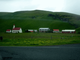 Church and houses west of town, viewed from the rental car on the Þjóðvegur road