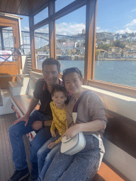 Tim, Miaomiao and Max at the ferry from Porto over the Douro river, with a view on the Ponte Luís I bridge and the Mosteiro da Serra do Pilar monastery