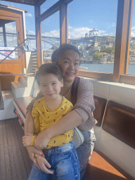 Miaomiao and Max at the ferry from Porto over the Douro river, with a view on the Ponte Luís I bridge and the Mosteiro da Serra do Pilar monastery