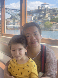 Miaomiao and Max at the ferry from Porto over the Douro river, with a view on the Ponte Luís I bridge and the Mosteiro da Serra do Pilar monastery