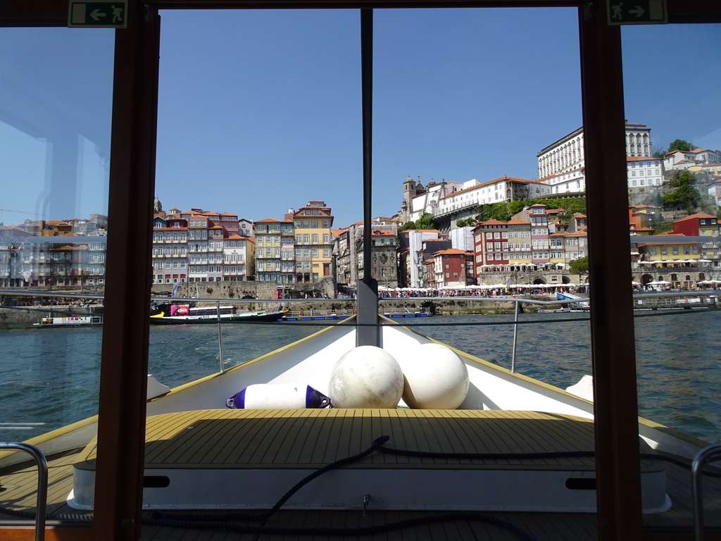 The ferry from Porto over the Douro river, with a view on Porto with the Cais da Ribeira street, the Igreja dos Grilos church and the Paço Episcopal do Porto palace