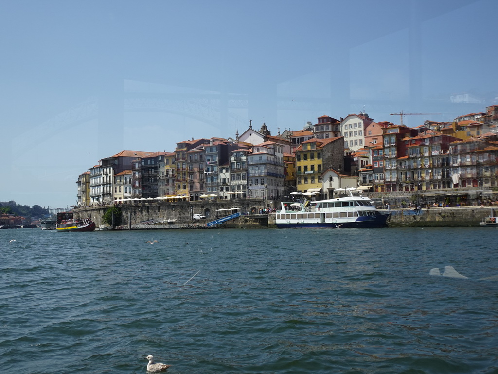 Boats and the Ponte da Arrábida bridge over the Douro river and Porto with the Cais da Estiva street, viewed from the ferry from Porto