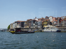 Boats and the Ponte da Arrábida bridge over the Douro river and Porto with the Cais da Estiva street, viewed from the ferry from Porto
