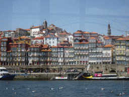 Boats on the Douro river and Porto with the Cais da Estiva street, the Igreja de Nossa Senhora da Vitória church and the Torre dos Clérigos tower, viewed from the ferry from Porto