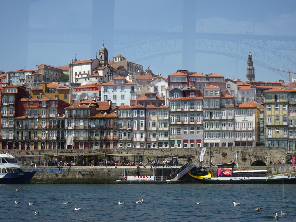 Boats on the Douro river and Porto with the Cais da Estiva street, the Igreja de Nossa Senhora da Vitória church and the Torre dos Clérigos tower, viewed from the ferry from Porto
