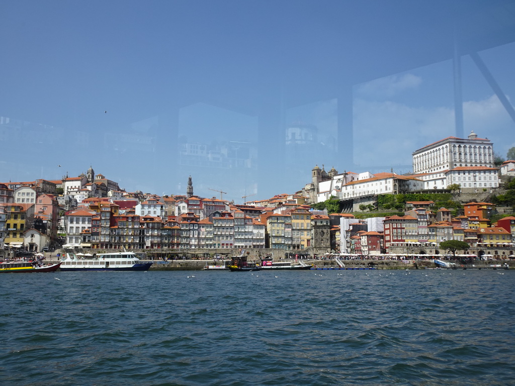 Boats on the Douro river and Porto with the Cais da Estiva and Cais da Ribeira streets, the Igreja de Nossa Senhora da Vitória church, the Torre dos Clérigos tower, the Igreja dos Grilos church and the Paço Episcopal do Porto palace, viewed from the ferry from Porto