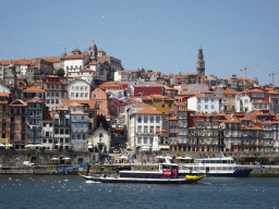 Boats on the Douro river and Porto with the Cais da Ribeira street, the Capela de Nossa Senhora do Ó chapel, the Mercado Ferreira Borges market, the Igreja de Nossa Senhora da Vitória church and the Torre dos Clérigos tower, viewed from the Avenida de Diogo Leite street