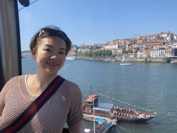 Miaomiao at the Gaia Cable Car, with a view on the Douro river and Porto with the Cais da Estiva street
