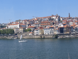 Boats on the Douro river and Porto with the Cais da Estiva street, Igreja de Nossa Senhora da Vitória church and the Torre dos Clérigos tower, viewed from the Gaia Cable Car