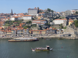 Boats on the Douro river and Porto with the Cais da Ribeira street, the Torre dos Clérigos tower, the Igreja dos Grilos church, the Porto Cathedral and the Paço Episcopal do Porto palace, viewed from the Gaia Cable Car