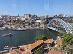 Boats and the Ponte Luís I bridge over the Douro river and Porto with the Cais da Ribeira street, the Igreja de Nossa Senhora da Vitória church, the Torre dos Clérigos tower, the Igreja dos Grilos church and the Paço Episcopal do Porto palace, viewed from the Gaia Cable Car