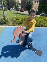 Max on a seesaw at the playground at the Jardim do Morro park