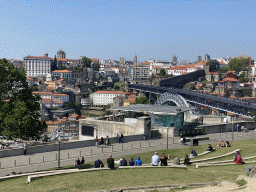 The Ponte Luís I bridge over the Douro river, the Gaia Cable Car building and Porto with the Paço Episcopal do Porto palace, the Porto Cathedral and the Muralha Fernandina wall, viewed from the rock hill at the Jardim do Morro park