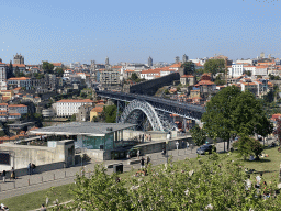 The Ponte Luís I bridge over the Douro river, the Gaia Cable Car building and Porto with the Paço Episcopal do Porto palace and the Muralha Fernandina wall, viewed from the rock hill at the Jardim do Morro park