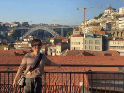 Miaomiao at the Main Square at the WOW Cultural District, with a view on the Ponte Luís I bridge over the Douro river and the Mosteiro da Serra do Pilar monastery