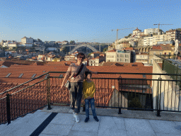 Miaomiao and Max at the Main Square at the WOW Cultural District, with a view on the Ponte Luís I bridge over the Douro river, the Mosteiro da Serra do Pilar monastery and Porto with the Igreja dos Grilos church and the Paço Episcopal do Porto palace