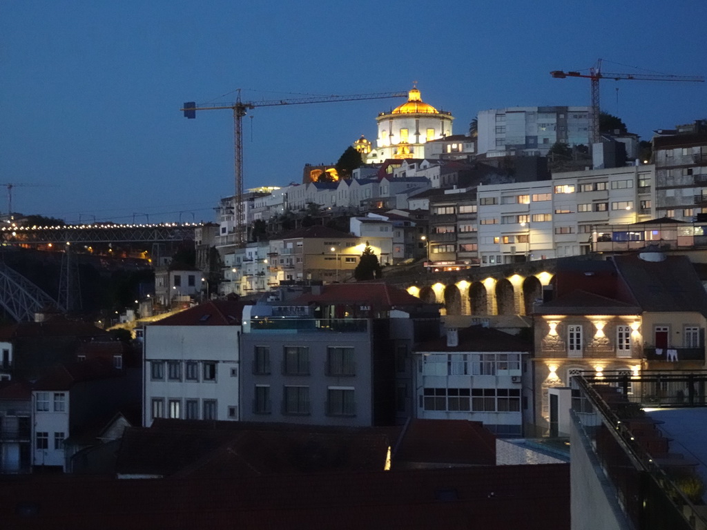 The Ponte Luís I bridge over the Douro river and the Mosteiro da Serra do Pilar monastery, viewed from the Main Square at the WOW Cultural District, at sunset