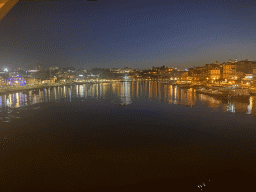Boats on the Douro river, Vila Nova de Gaia and Porto, viewed from the lower level of the Ponte Luís I bridge, by night